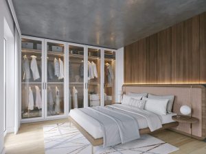 dormitorio con un gran vestidor con puertas de cristal tipo vitrinas